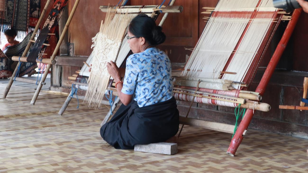 A Sumbanese weaver working at a traditional loom