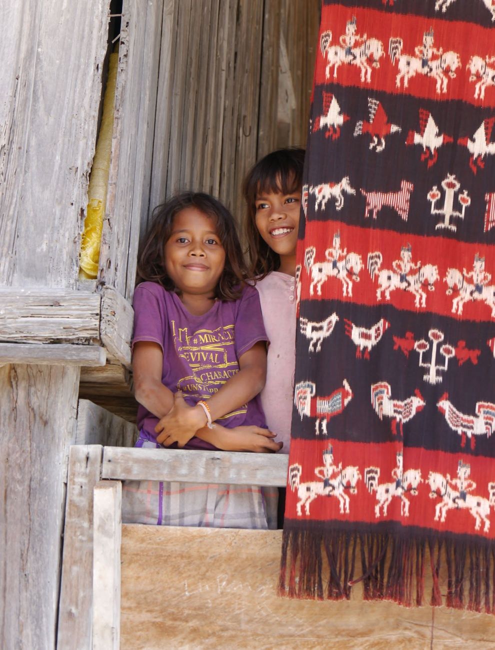 Girls beside a hand-woven ikat, East Sumba — Day 10
